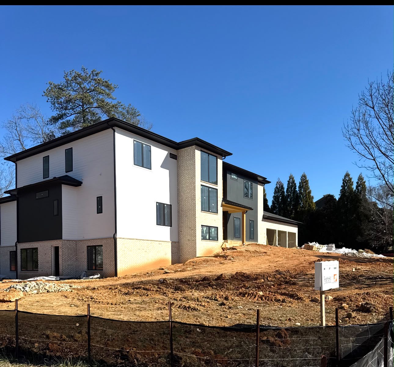 Modern white and charcoal home nearing exterior completion